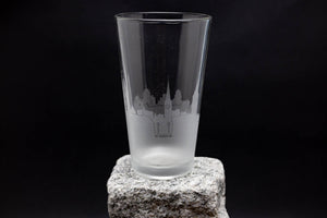 a tall glass sitting on top of a rock