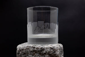 a clear glass sitting on top of a rock