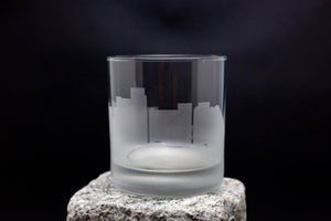 a glass sitting on top of a rock