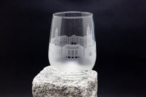 a wine glass sitting on top of a rock