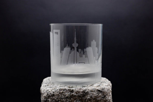 a glass with a city skyline etched on it