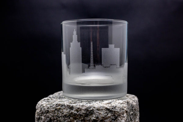 a shot glass sitting on top of a rock