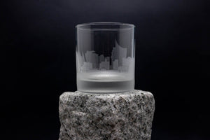 a glass sitting on top of a rock