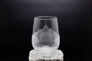 a glass sitting on top of a rock