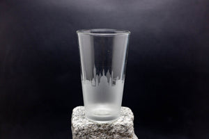 a tall glass sitting on top of a rock