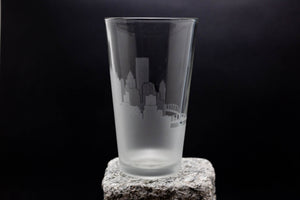 a tall glass sitting on top of a rock