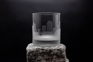 a glass sitting on top of a rock