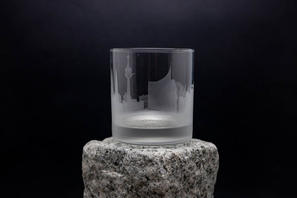 a glass sitting on top of a rock