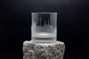 a clear glass sitting on top of a rock