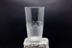 a tall glass sitting on top of a rock