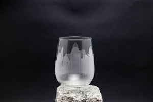 a glass sitting on top of a rock