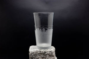 a tall glass sitting on top of a rock