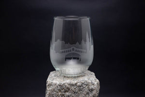 a glass sitting on top of a rock