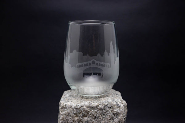 a glass sitting on top of a rock