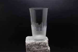 a tall glass sitting on top of a rock