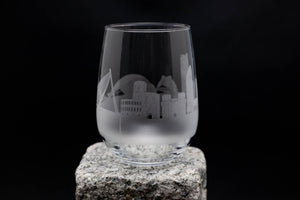 a glass sitting on top of a rock