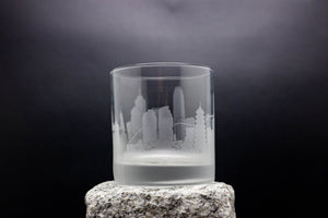 a glass with a city skyline etched on it