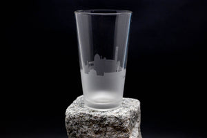 a tall glass sitting on top of a rock