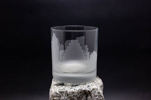 a glass sitting on top of a rock