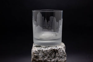 a glass sitting on top of a rock