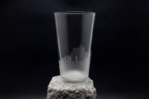 a tall glass sitting on top of a rock