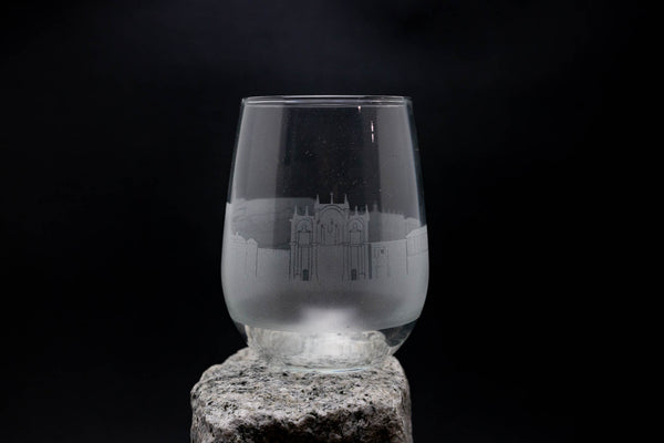 a wine glass sitting on top of a rock