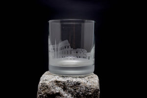a clear glass sitting on top of a rock