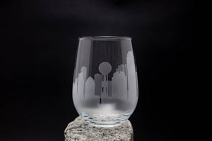 a glass with a city skyline etched on it