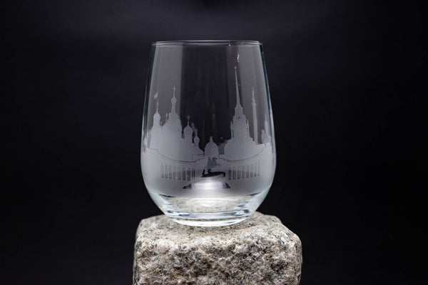 a wine glass sitting on top of a rock