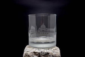 a shot glass sitting on top of a rock