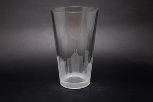 a clear glass with a city skyline etched on it