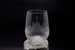 a glass on a rock with a black background