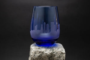 a blue glass sitting on top of a rock