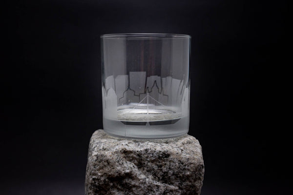 a glass on top of a rock on a black background