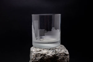 a glass sitting on top of a rock