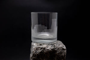 a glass sitting on top of a rock